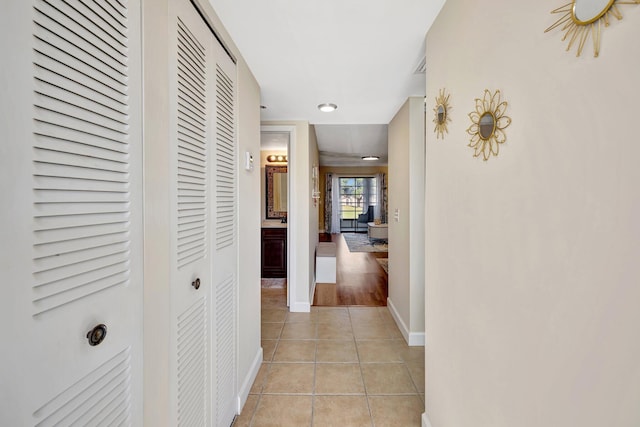 corridor featuring light tile patterned floors