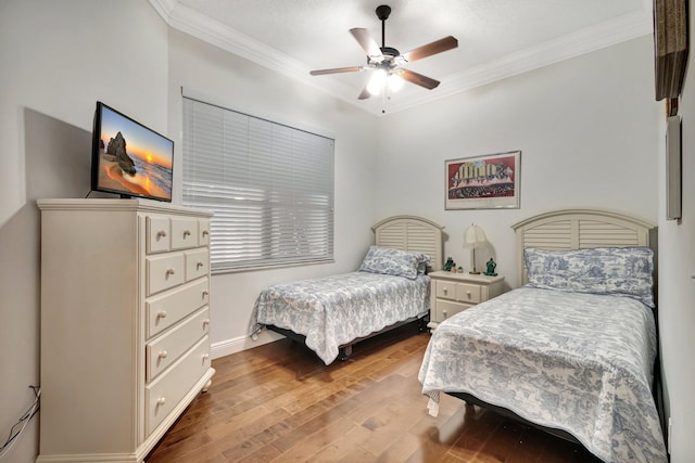 bedroom featuring ceiling fan, light hardwood / wood-style floors, and ornamental molding