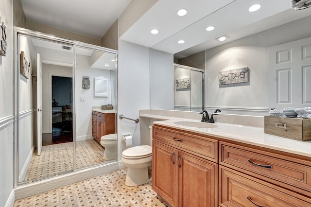 bathroom with vanity, toilet, and walk in shower