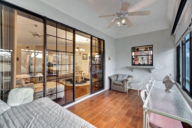 bedroom with multiple windows, wood-type flooring, and a notable chandelier