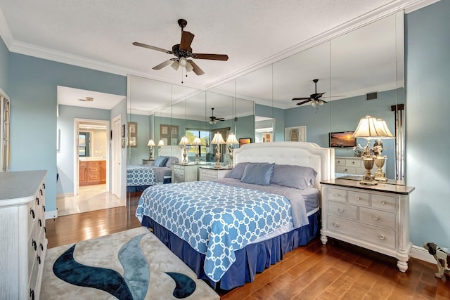 bedroom with ceiling fan, dark hardwood / wood-style flooring, ensuite bathroom, and ornamental molding