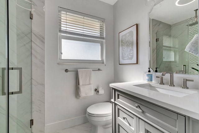 bathroom with toilet, vanity, and walk in shower