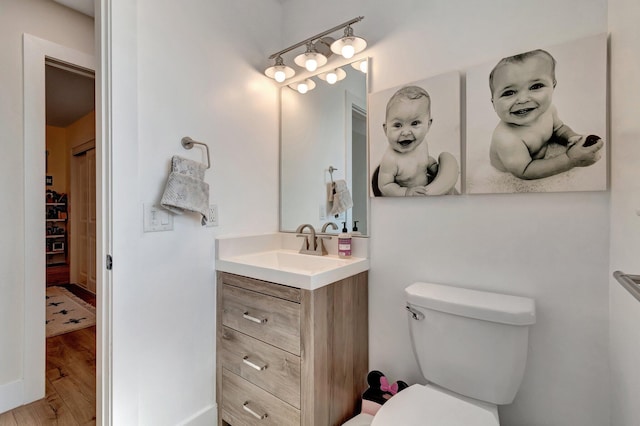 bathroom featuring hardwood / wood-style floors, vanity, and toilet