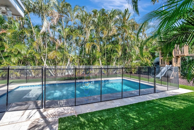 view of pool with a yard