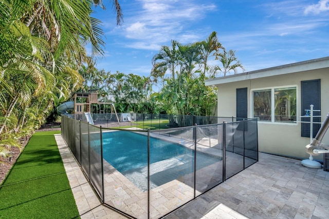 view of pool featuring a playground and a patio area