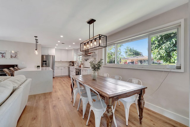 dining area featuring light hardwood / wood-style floors and a chandelier