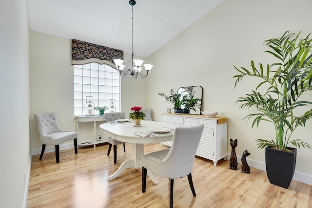 7708 Cherry Blossom Way, Boynton Beach, FL 33437 - dining space featuring a chandelier, light wood-type flooring, and vaulted ceiling