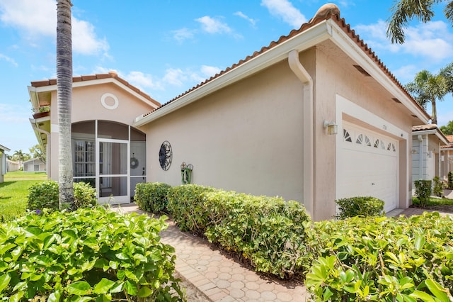 7708 Cherry Blossom Way, Boynton Beach, FL 33437 - view of property exterior featuring a garage, stucco siding, and a tile roof