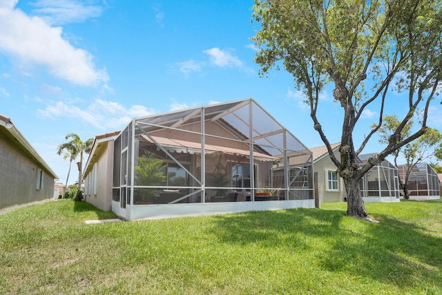 7708 Cherry Blossom Way, Boynton Beach, FL 33437 - rear view of property with a yard, stucco siding, and a lanai