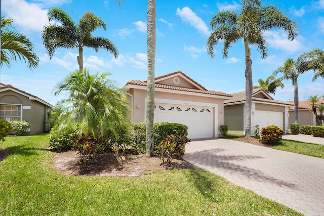 7708 Cherry Blossom Way, Boynton Beach, FL 33437 - view of front of house with stucco siding, a tile roof, an attached garage, decorative driveway, and a front lawn