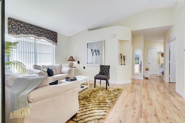 7708 Cherry Blossom Way, Boynton Beach, FL 33437 - living room featuring lofted ceiling, light wood-style floors, and healthy amount of natural light