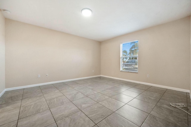 empty room with tile patterned flooring