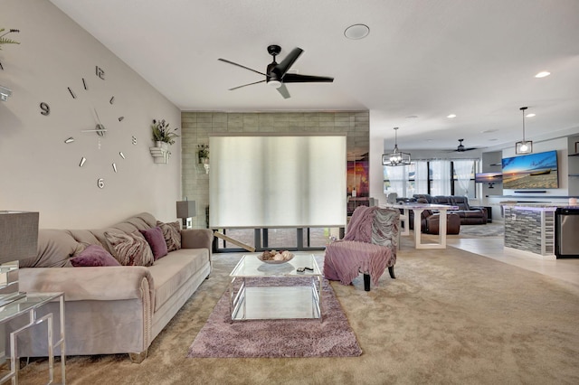 carpeted living room featuring ceiling fan with notable chandelier