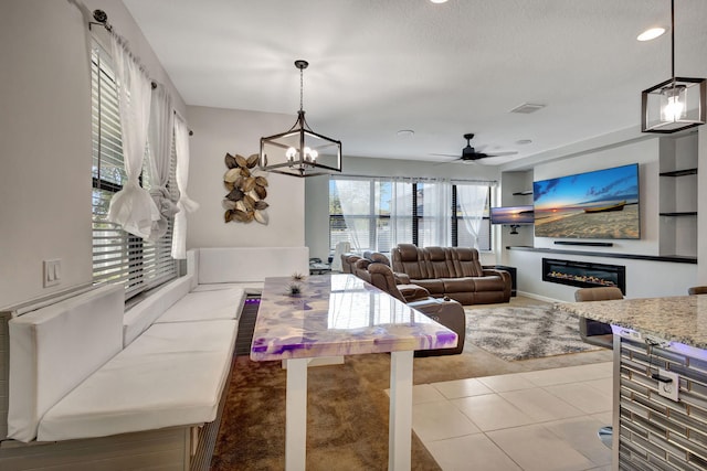 kitchen featuring pendant lighting, a healthy amount of sunlight, and light colored carpet