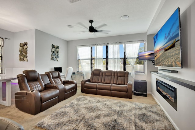 living room with light carpet, a textured ceiling, and ceiling fan