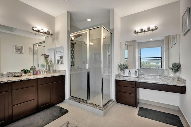 bathroom featuring tile patterned flooring, vanity, and an enclosed shower