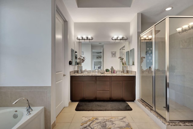 bathroom with tile patterned flooring, shower with separate bathtub, and vanity