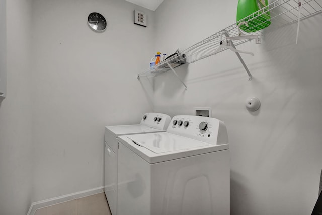 washroom featuring washer and clothes dryer