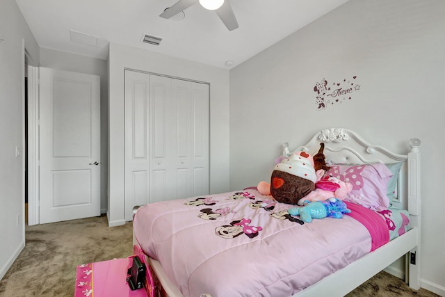 carpeted bedroom featuring ceiling fan and a closet