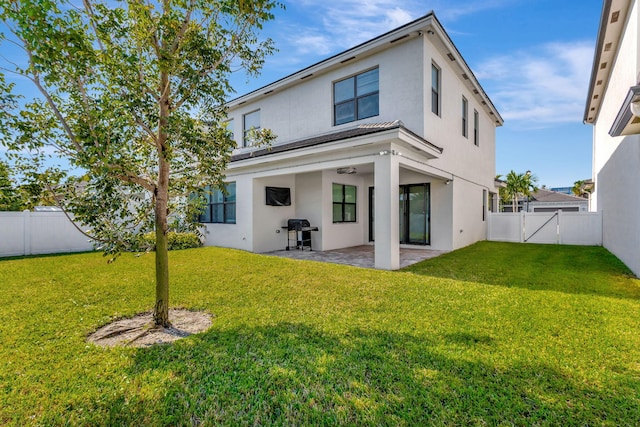 back of property featuring a patio area and a yard