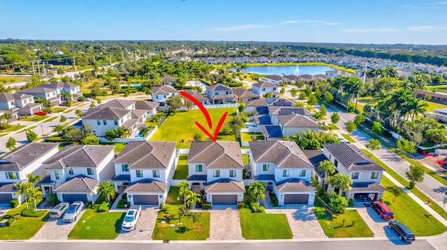 birds eye view of property with a water view