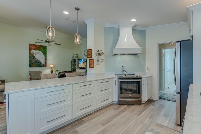 kitchen with premium range hood, kitchen peninsula, white cabinetry, and appliances with stainless steel finishes