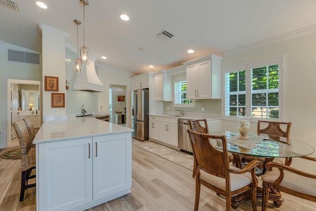 kitchen featuring white cabinets, backsplash, kitchen peninsula, and stainless steel appliances