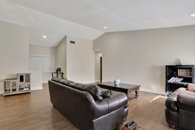 living room with lofted ceiling and wood-type flooring