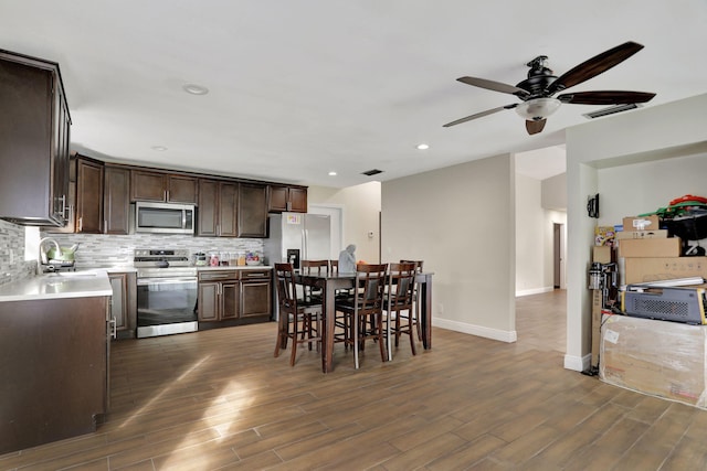 dining space with sink and ceiling fan