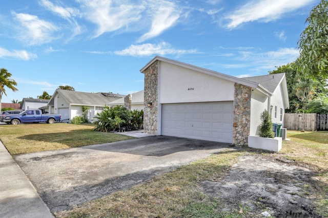 view of front of house with a front yard and a garage