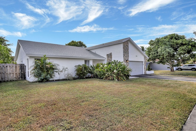 view of front of property with a garage and a front lawn