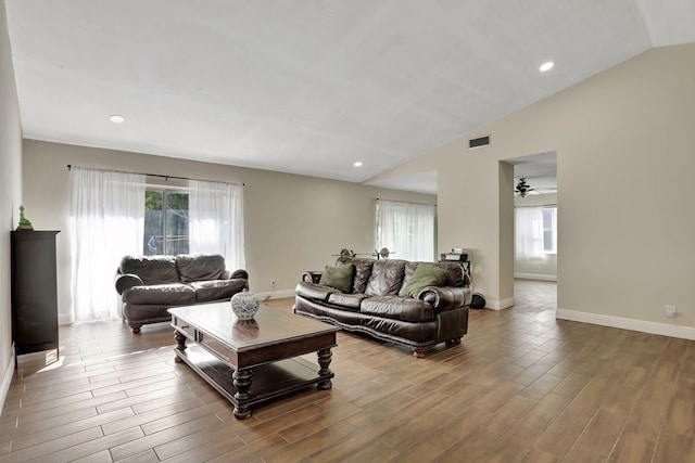 living room featuring a healthy amount of sunlight and vaulted ceiling