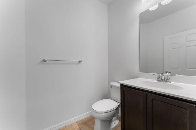 bathroom featuring vanity, tile patterned floors, and toilet