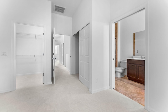 interior space featuring vanity and toilet