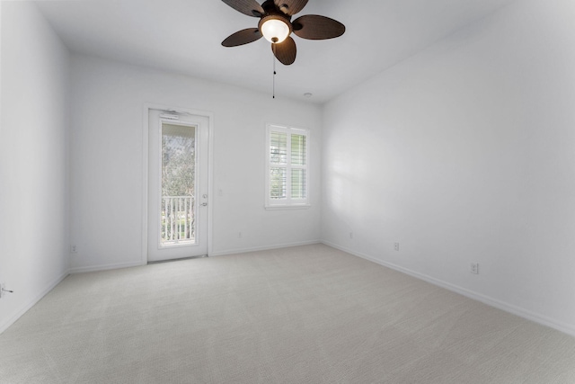 empty room featuring light colored carpet and ceiling fan