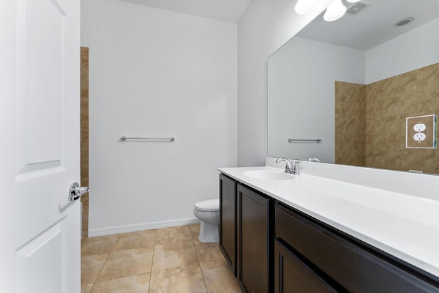 bathroom with vanity, toilet, and tile patterned flooring