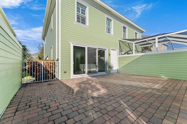 rear view of house featuring a lanai and a patio