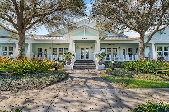 bungalow-style house with french doors and covered porch