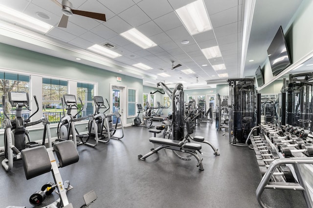 gym with a drop ceiling and ceiling fan