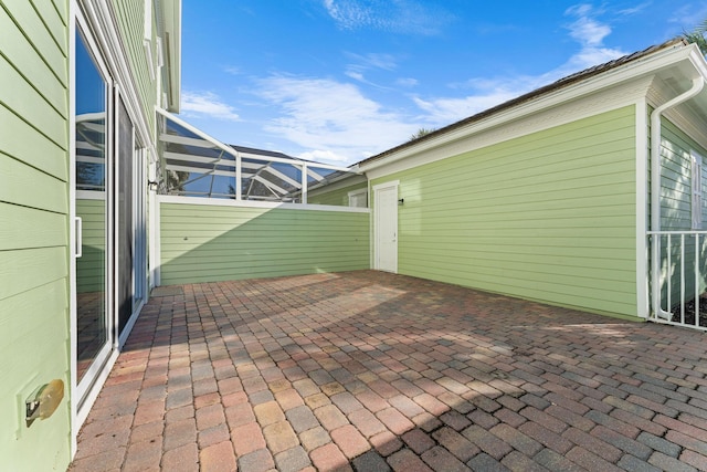 view of patio / terrace featuring glass enclosure