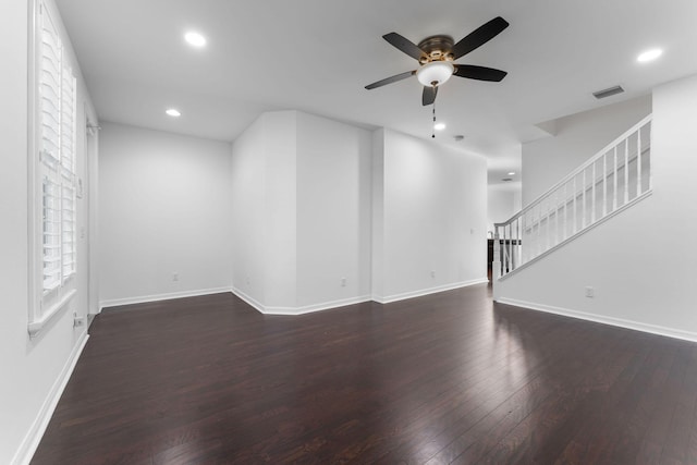 unfurnished living room featuring ceiling fan and dark hardwood / wood-style flooring