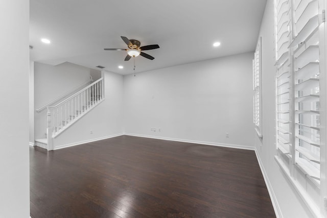 unfurnished living room with dark hardwood / wood-style floors and ceiling fan