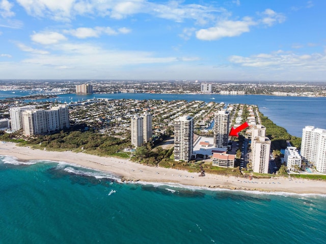 drone / aerial view with a water view and a beach view