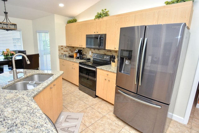 kitchen with tasteful backsplash, light brown cabinets, lofted ceiling, stainless steel appliances, and a sink