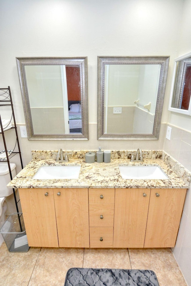 bathroom with tile patterned floors, vanity, and toilet