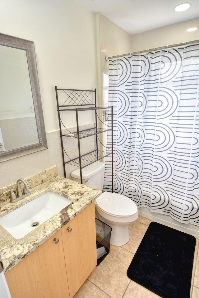 bathroom featuring tile patterned floors, vanity, and toilet