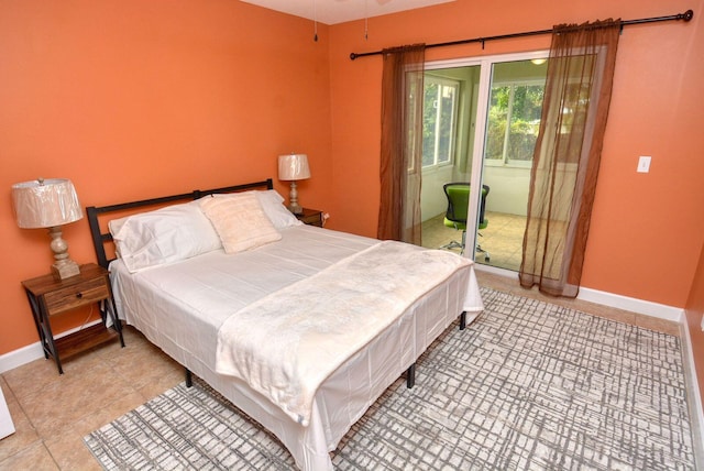 bedroom with light tile patterned floors, baseboards, and access to outside