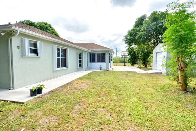 view of yard featuring an outbuilding, a shed, and a patio