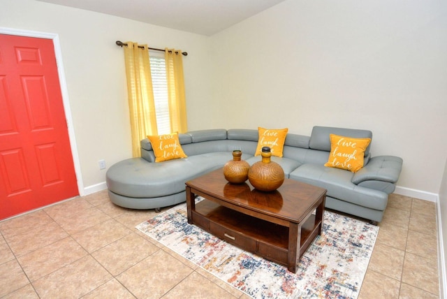 living area featuring tile patterned floors and baseboards