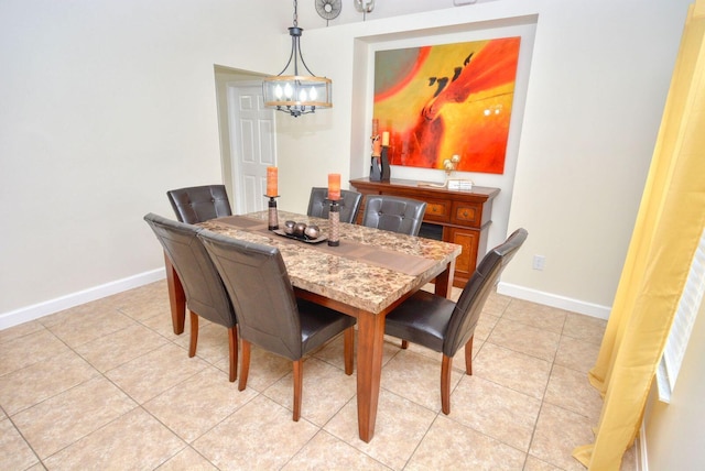 dining room featuring light tile patterned floors, baseboards, and a notable chandelier